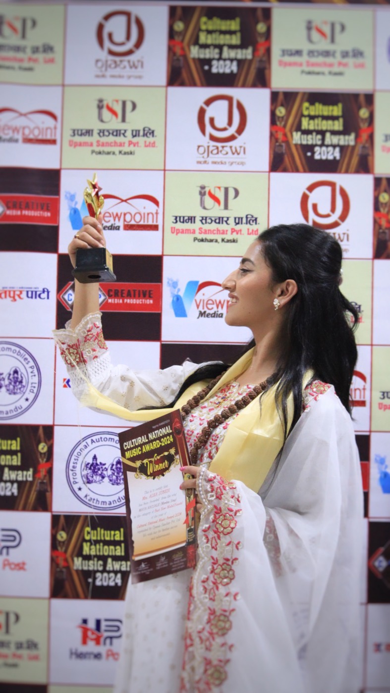 Alka Subedi raising her trophy at the Cultural National Music Award 2024