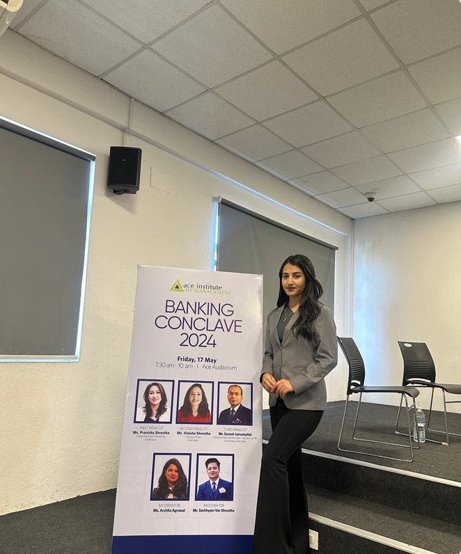 Alka Subedi beside the Banking Conclave 2024 banner