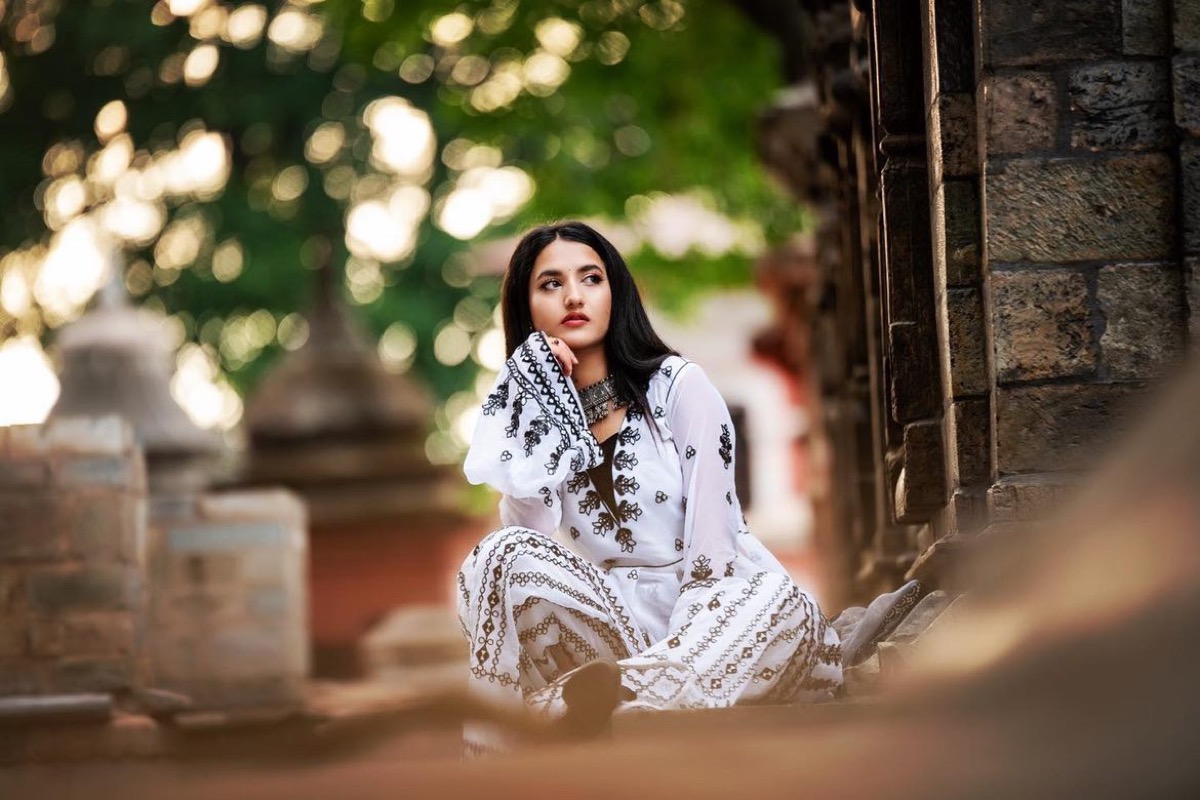 Alka Subedi seated at a temple courtyard in Kathmandu
