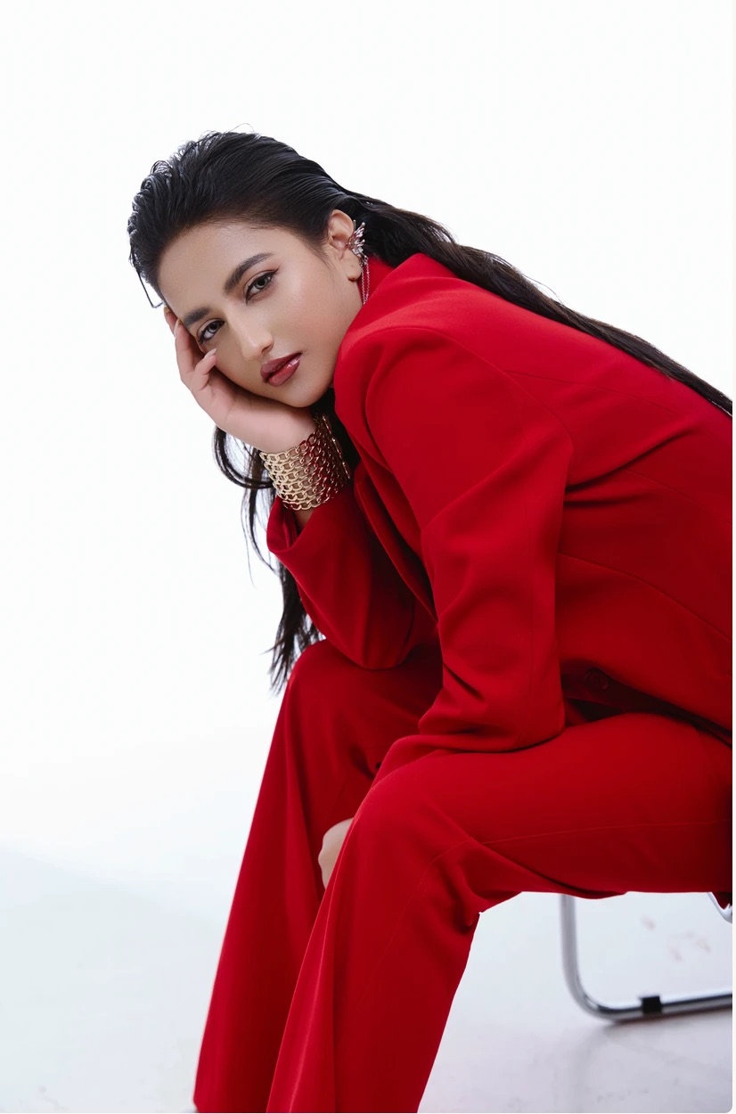 Alka Subedi in a red suit, studio portrait